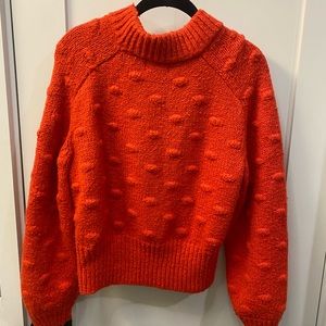 Red knit sweater with cute detailing